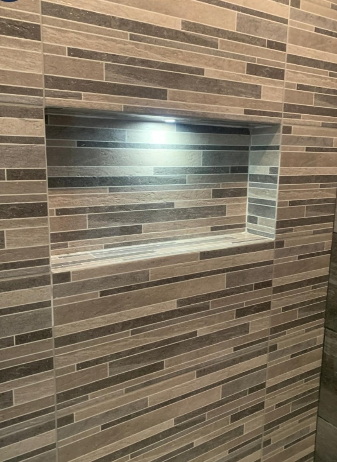 Illuminated tiled bathroom niche from a WMB project
